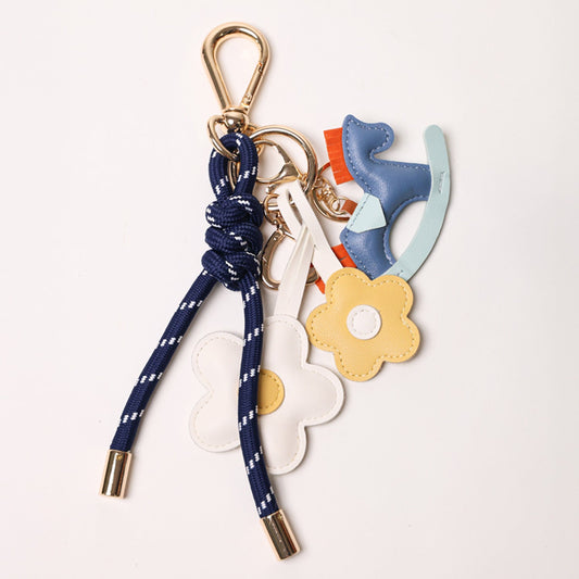 KEY CHAIN DEEP BLUE WITH CHARMS - YELLOW DAISIES AND BLUE ROCKING HORSE