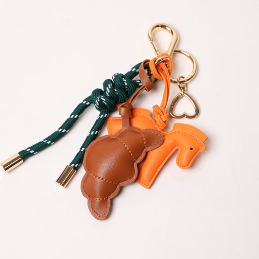 KEY CHAIN EMERALD WITH CHARMS - BROWN CROISSANT AND ORANGE HORSE