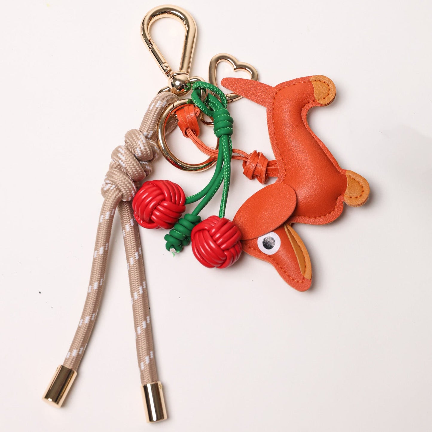 KEY CHAIN TAUPE WITH CHARMS - RED CHERRIES AND ORANGE DOG