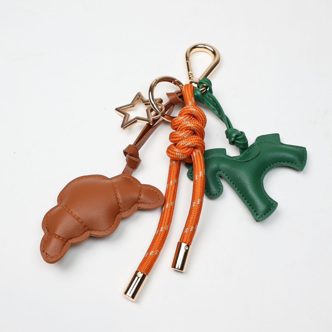 KEY CHAIN BURN ORANGE WITH CHARMS - GREEN HORSE AND BROWN CROISSANT