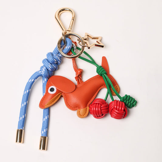 KEY CHAIN BLUE WITH CHARMS - ORANGE DOG AND RED CHERRIES