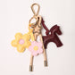 KEY CHAIN TAN WITH CHARMS - BURGUNDY HORSE AND YELLOW/PINK DAISIES