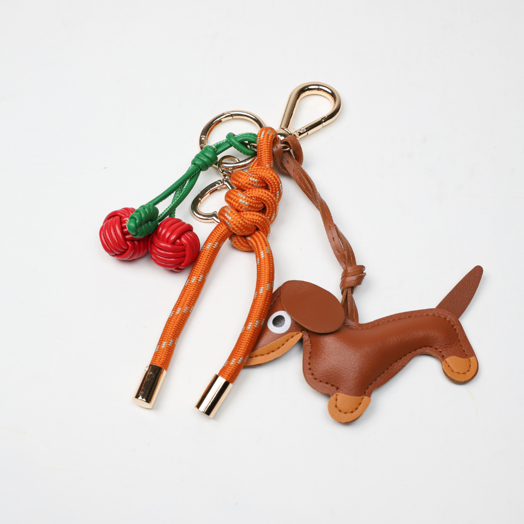 KEY CHAIN BURN ORANGE WITH CHARMS - BROWN DOG AND RED CHERRIES